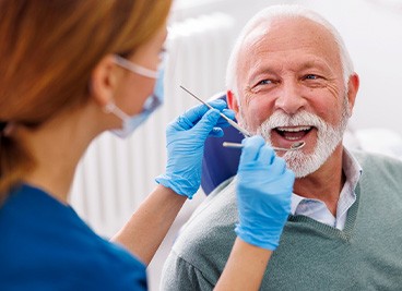 Man smiles at dental hygienist