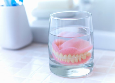 Dentures soaking in a special cleaning solution