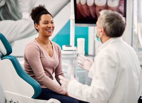 Patient and dentist consulting about dental bonding details