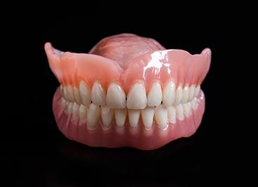 Set of full dentures on a table