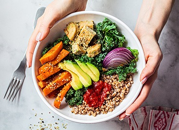 Patient holding bowl filled with healthy food